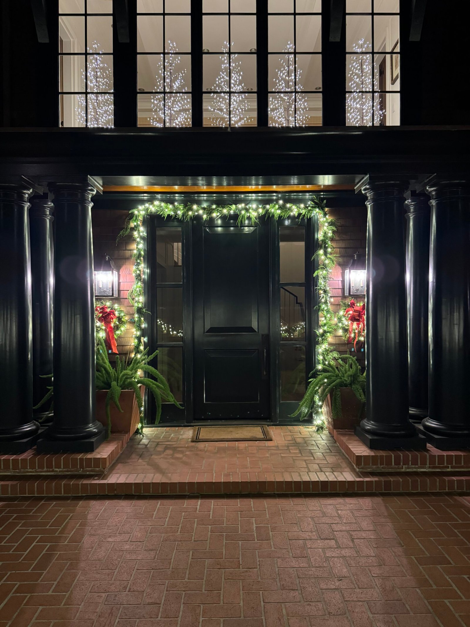 Holiday wreaths garland and lighting on a residential balcony