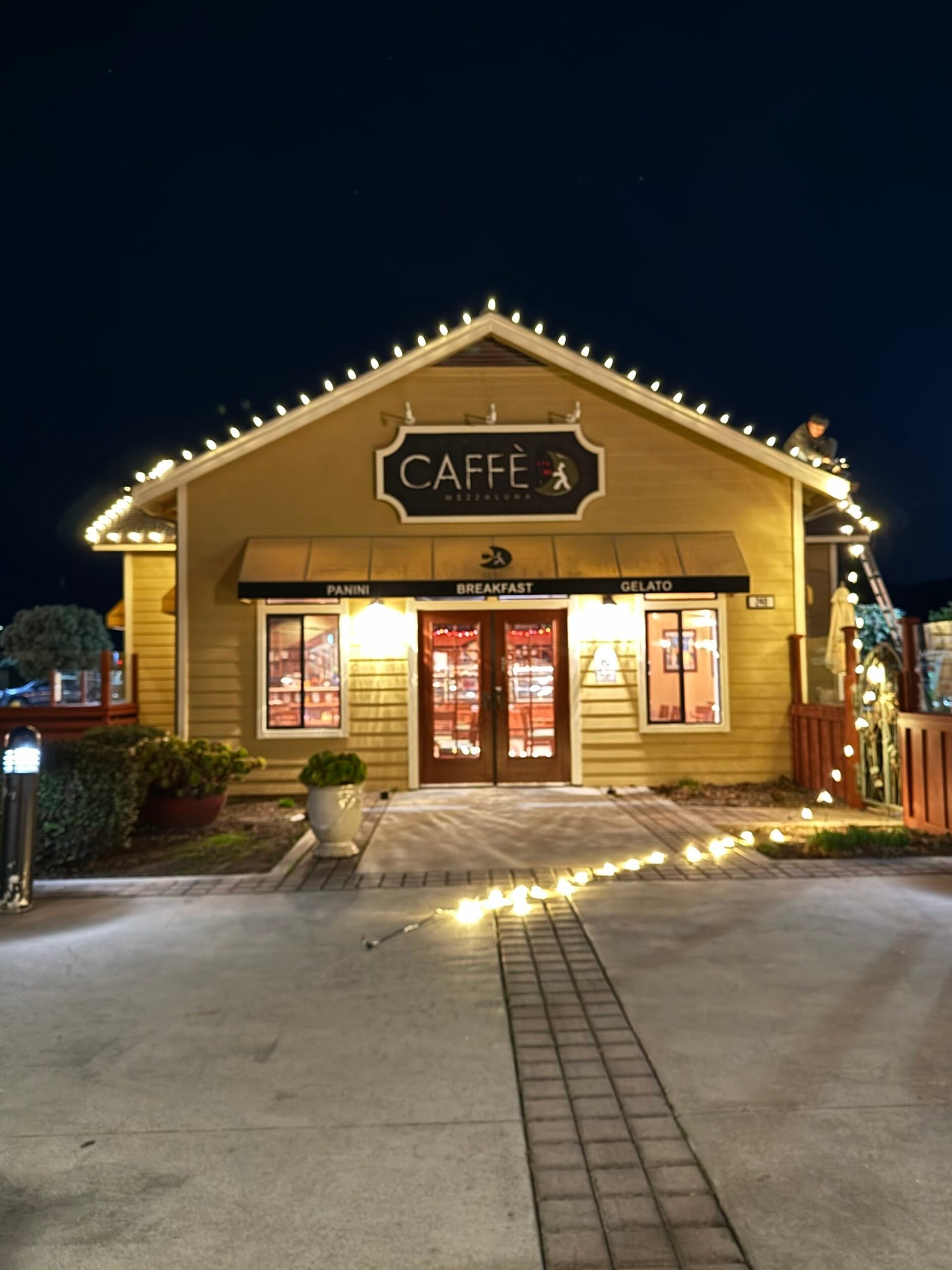 Holiday roofline lighting on a commercial storefront